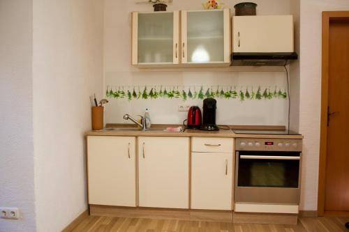 a kitchen with white cabinets and a sink at Allgäuer Stuben für einen vielfältigen Allgäu Urlaub in Kempten