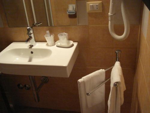 a bathroom with a white sink and a shower at La Campana D'Oro in Beverino