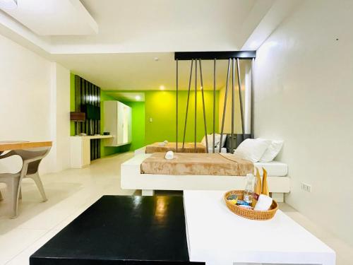 a bedroom with a bed and a living room at Amable Suites Hotel in Boracay