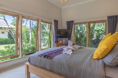 a bedroom with a bed with two stuffed animals on it at InBalance Resort in Buleleng