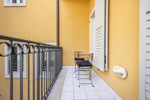 a balcony with chairs and a table on it at Residenza Ester in Riva del Garda