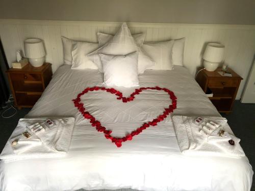a heart made out of pillows on a bed at Valley View Luxury Retreat in Vacy