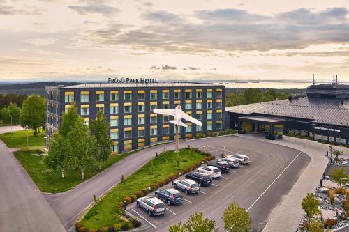 a building with cars parked in a parking lot at Frösö Park Hotel in Östersund