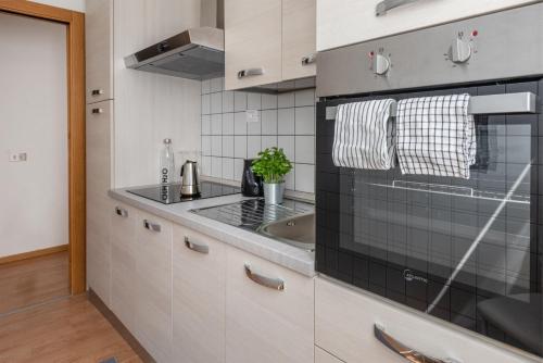 a kitchen with a sink and a stove top oven at Residenza Ester in Riva del Garda