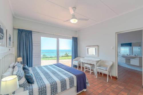 a bedroom with a bed and a view of the ocean at 2C Edward Place in Ballito