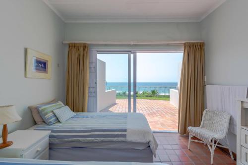 a bedroom with a bed and a view of the ocean at 2C Edward Place in Ballito