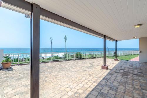 an empty patio with a view of the ocean at 2C Edward Place in Ballito