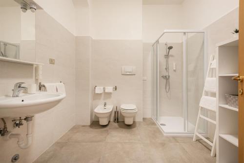 a bathroom with a sink and a toilet and a shower at Residenza Ester in Riva del Garda