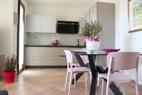 a kitchen with a dining room table and chairs at Casa Mari in Villasimius