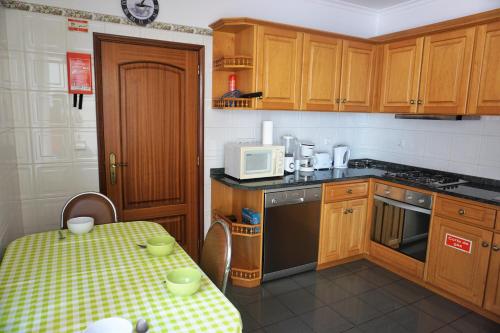 a kitchen with a table and a microwave at !Your Home In Madeira in Funchal