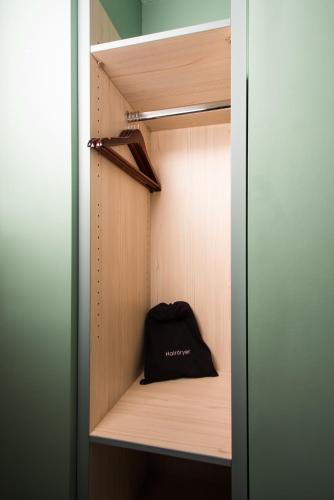 a black bag is sitting in a closet at Caring Hotel in London