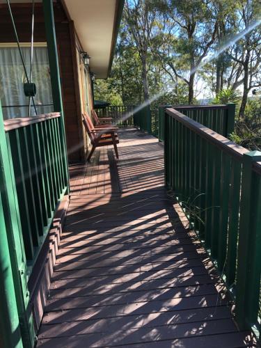 a porch of a house with a bench on it at Valley View Luxury Retreat in Vacy