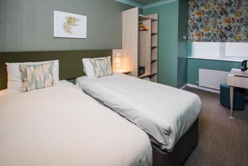a bedroom with two beds in a room at Caring Hotel in London
