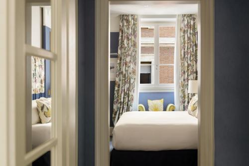 a hotel room with a bed and a window at Maalot Roma - Small Luxury Hotels of the World in Rome
