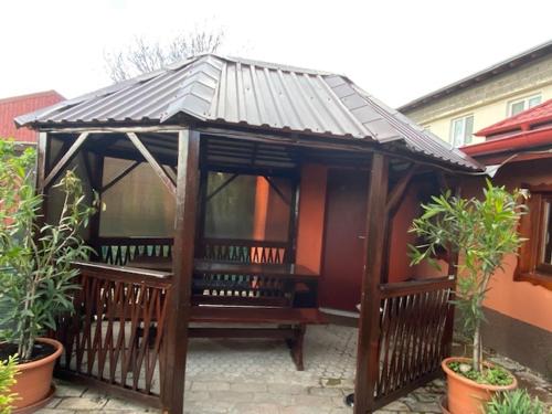 a wooden gazebo with a roof in a yard at Holiday Home V Kolte in Kolta