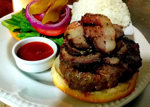 a plate of food with meat and rice and sauce at Pundak guesthouse in Moshav Ramot