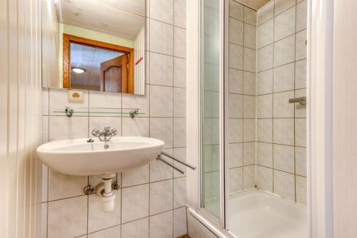 a bathroom with a sink and a shower at Château Ferme de Laval in Sainte-Ode