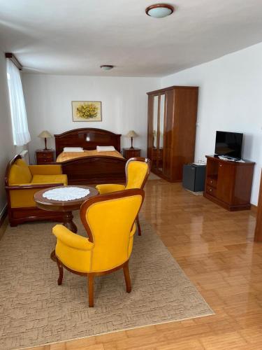 a bedroom with a bed and a table and chairs at Vila Punta in Šibuljina
