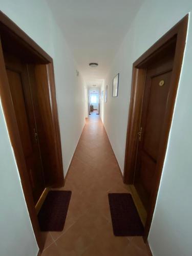 a hallway with two doors and a long corridor at Vila Punta in Šibuljina
