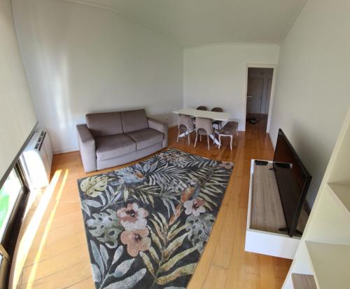 a living room with a couch and a table at Azores Avenida E Apartment T3 in Ponta Delgada