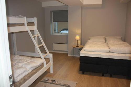 a bedroom with two bunk beds and a window at Meget flott leilighet i Stryn sentrum in Stryn