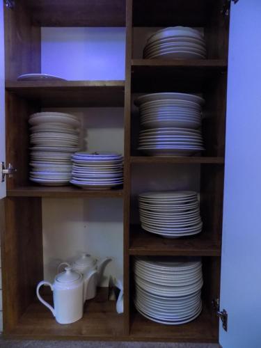 a cabinet filled with plates and cups and dishes at Pokoje u Teresy in Czarna Góra