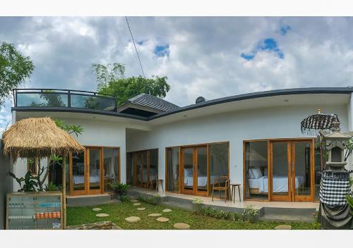a house with a view of a bedroom at Villa Manayasa in Lovina