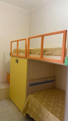 a bunk bed in a small room with a bunk bedutenewayewayangering at La Maison in Mondragone