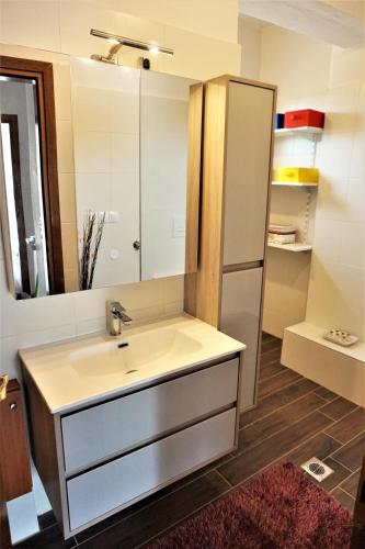a bathroom with a sink and a mirror at Katerinas House in Nikiti