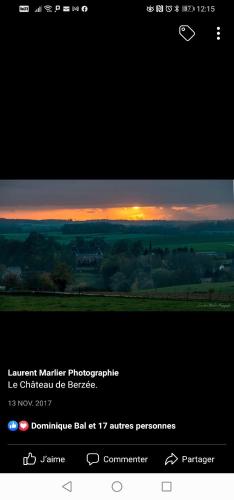 a computer screen with a picture of a sunset at Maison d'hôtes Les Notes Endormies in Walcourt