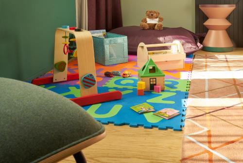 a childs play area with toys on the floor at Sorell Hotel City Weissenstein - Boutique Hotel in St. Gallen
