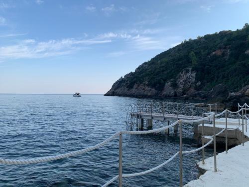 
a pier overlooking the ocean with a view of the water at Il Pellicano in Porto Ercole
