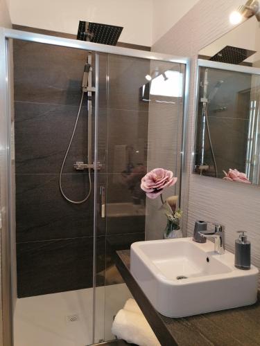 a bathroom with a sink and a shower at Hotel Antica Cascina Del Golfo in Scopello