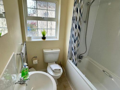 a bathroom with a sink and a toilet and a tub at St Margarets House - Modern - 3 Bed Townhouse - Parking - Marvello Properties in Norwich