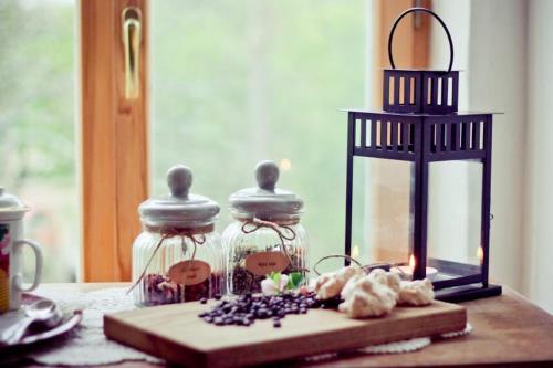 two glass jars sitting on a table with a candle at Zemzari in Jūrkalne