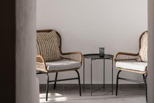 two wicker chairs and a table in a room at Kastro Mansion in Pirgos