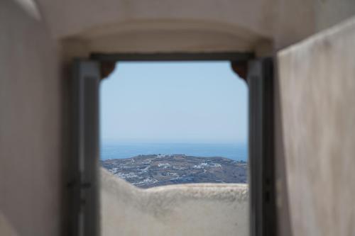 a view of a city from a window at Kastro Mansion in Pirgos