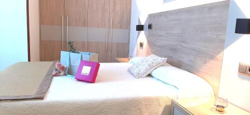 a hotel room with a bed with a sign on it at Hotel Nueva Plaza in Maliaño