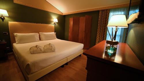 Postel nebo postele na pokoji v ubytování Best Western Grand Hotel Guinigi