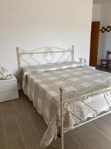 a bedroom with a bed with a teddy bear on it at Agriturismo Azzarone in Vieste