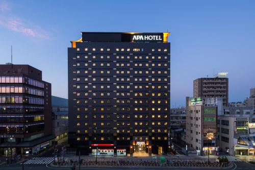 a building with an am hotel on top of it at APA Hotel Sugamo Ekimae in Tokyo