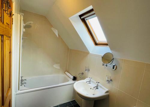 a bathroom with a sink and a bath tub at Church House Farm in Danby