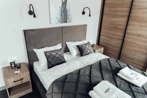 a bedroom with a large bed with two pillows at готель Тячів in Tyachiv