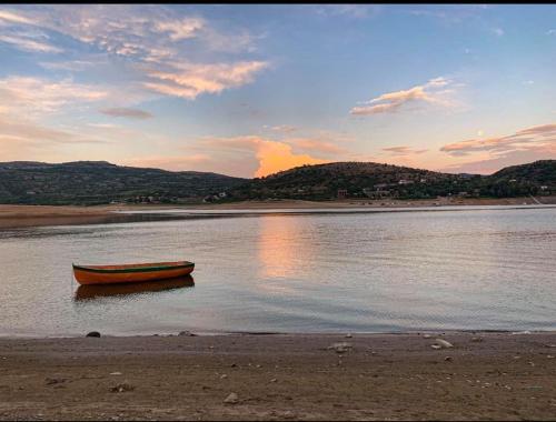 a boat sitting in the water on a beach at Villa Exotic in Kavadarci