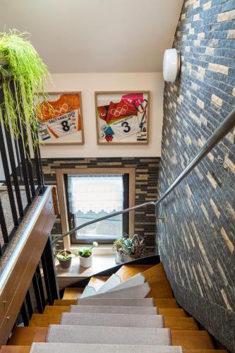 a staircase in a house with a brick wall at Pension Hotel Sartor in Kurort Altenberg