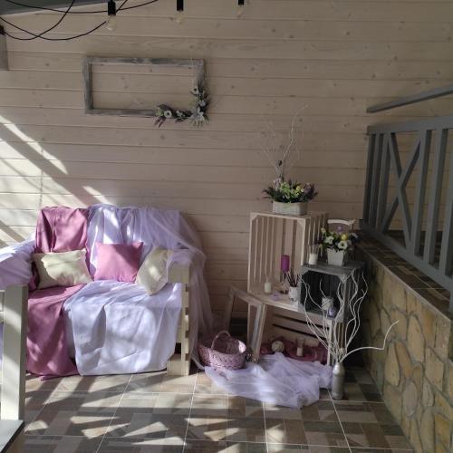 a living room with a chair and a table at Фенікс in Yaremche