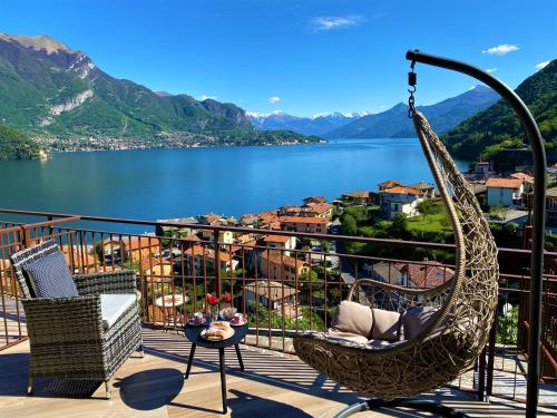 a hanging hammock on a balcony overlooking a lake at Il Bellavista in Lezzeno
