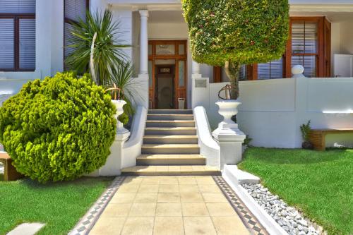 a house with a staircase leading to the front door at Cape Diem Lodge in Cape Town