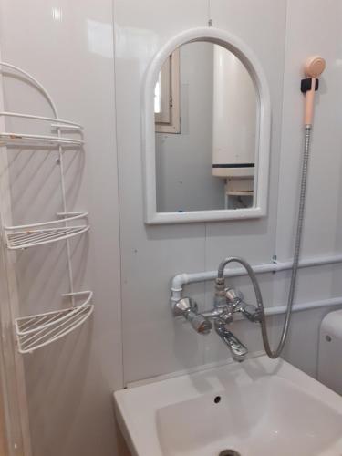 a bathroom with a sink and a mirror at Бунгала Дъбрава in Shkorpilovtsi
