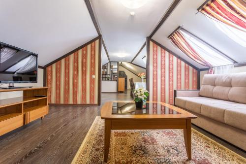 a living room with a couch and a table at Hotel Pechory-Park in Pechory